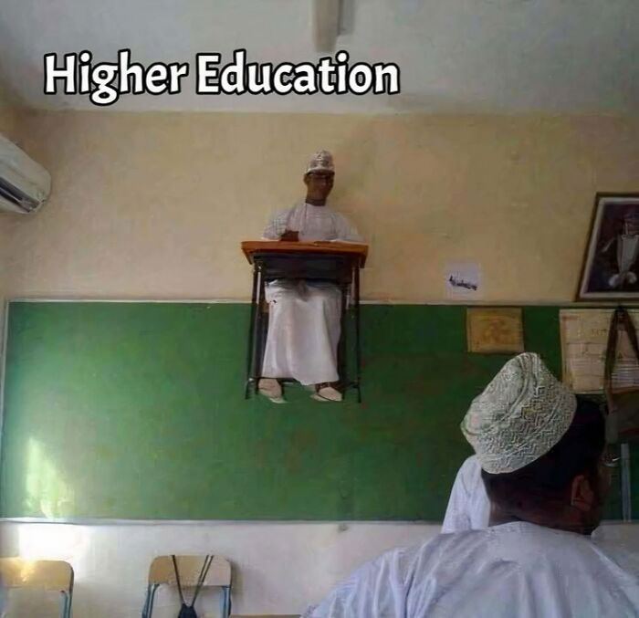 "Student humorously shown at a high desk labeled 'Higher Education' in a classroom setting, combining science and humor."