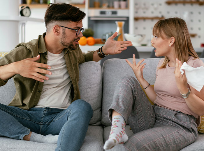A couple arguing on the couch about kids and family issues, with emotional expressions and gestures. A couple arguing on the couch about kids and family issues, with emotional expressions and gestures.