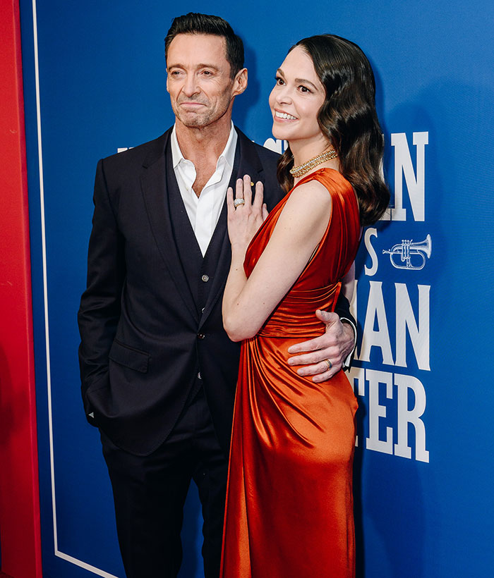 Man in suit with a mysterious woman in an elegant red dress at an event. Man in suit with a mysterious woman in an elegant red dress at an event.