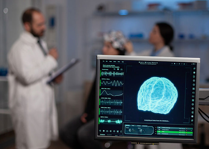 Brain surgery observation with doctors in discussion, displaying an MRI scan on the monitor. Brain surgery observation with doctors in discussion, displaying an MRI scan on the monitor.
