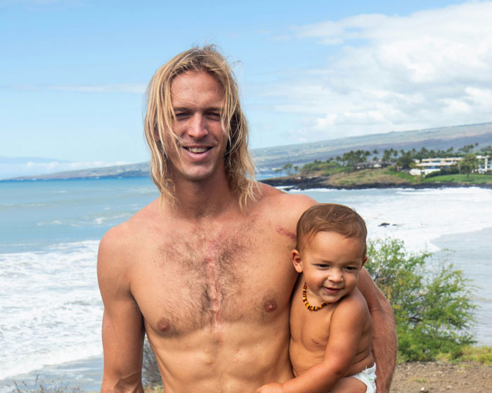 Man holding a toddler on a beach with waves in the background, highlighting family connection issues over features. Man holding a toddler on a beach with waves in the background, highlighting family connection issues over features.