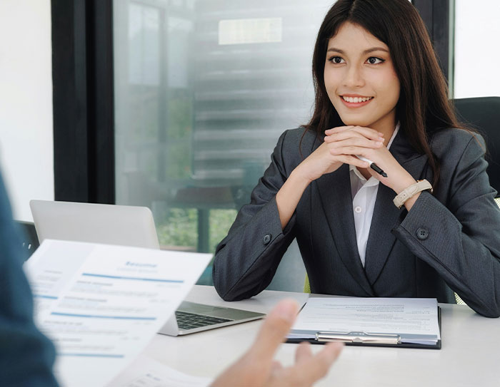 Candidate in a job interview, looking intrigued as expectations and salary are discussed. Candidate in a job interview, looking intrigued as expectations and salary are discussed.