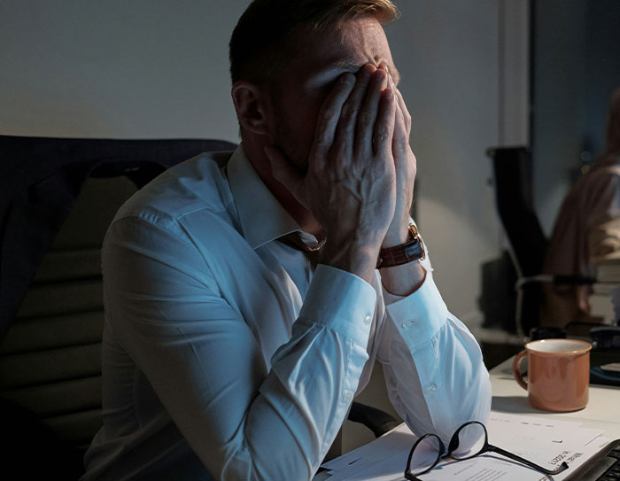 Candidate in a job interview, visibly stressed after being shown expectations and salary, in an office setting. Candidate in a job interview, visibly stressed after being shown expectations and salary, in an office setting.