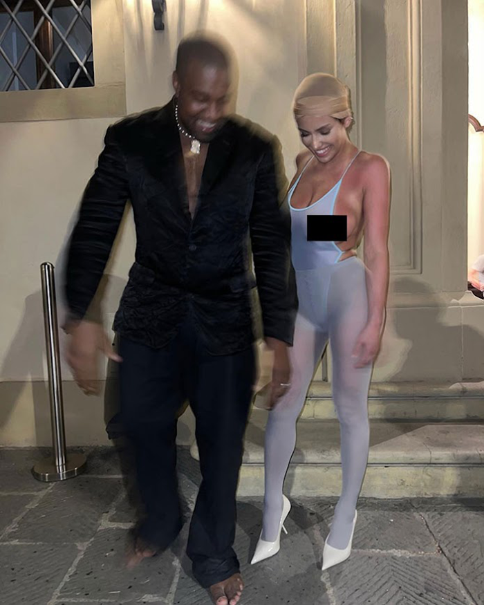 Ye and Bianca Censori in formal attire, with woman in sheer outfit, standing outside a building at night, related to Kim Kardashian and Bianca. Ye and Bianca Censori in formal attire, with woman in sheer outfit, standing outside a building at night, related to Kim Kardashian and Bianca.