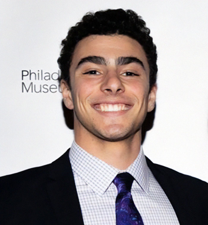 Luigi Mangione in suit poses at an event, related to Luigi Mangione's manifesto leak. Luigi Mangione in suit poses at an event, related to Luigi Mangione's manifesto leak.