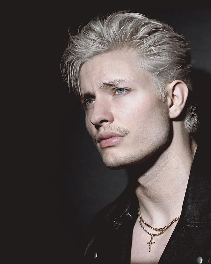 Matt Rife with a drastically different look, wearing a leather jacket and gold necklace, in a dimly lit setting. New comedy special poster Matt Rife with a drastically different look, wearing a leather jacket and gold necklace, in a dimly lit setting. New comedy special poster