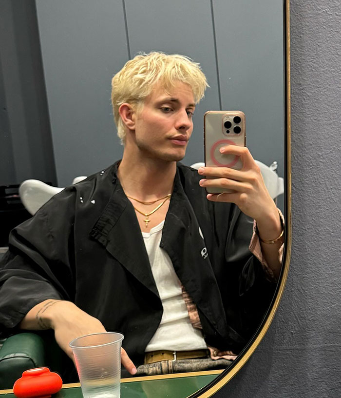 Matt Rife with blonde hair takes a selfie in front of a mirror, sparking plastic surgery rumors. Matt Rife with blonde hair takes a selfie in front of a mirror, sparking plastic surgery rumors.