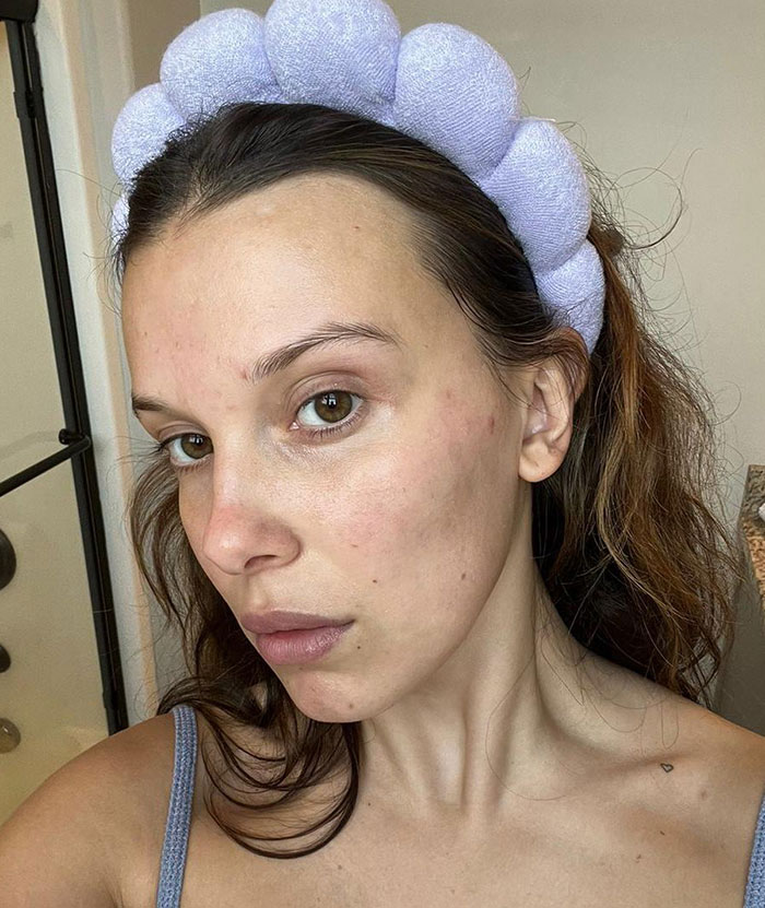 Young person with purple headband, neutral expression, clear skin, and wearing a sleeveless top. Young person with purple headband, neutral expression, clear skin, and wearing a sleeveless top.