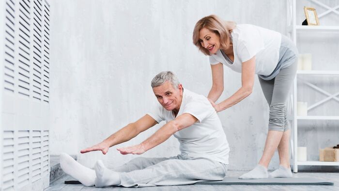 Elderly couple exercising together.