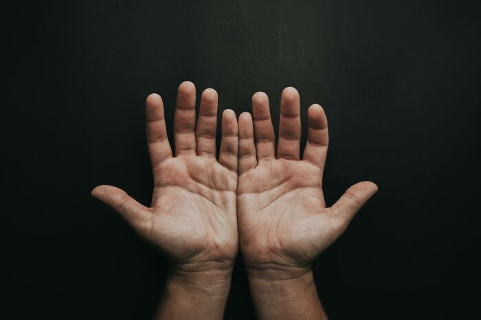 Hands extended with palms facing up, illustrating a rare everyday fact concept.