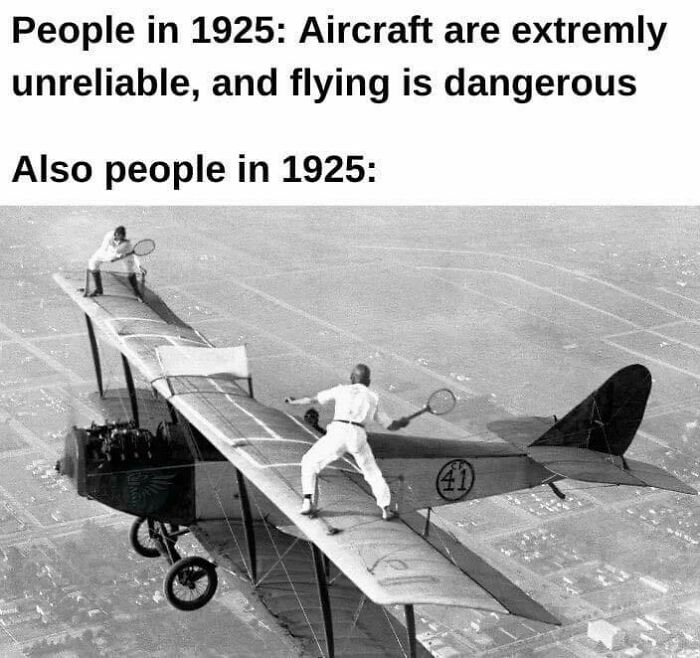Two people in 1925 playing tennis on a biplane wing, combining history and humor in a science meme.