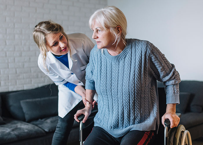 Caregiver assisting elderly woman in a wheelchair at a care facility, focusing on family dynamics and holiday challenges. Caregiver assisting elderly woman in a wheelchair at a care facility, focusing on family dynamics and holiday challenges.
