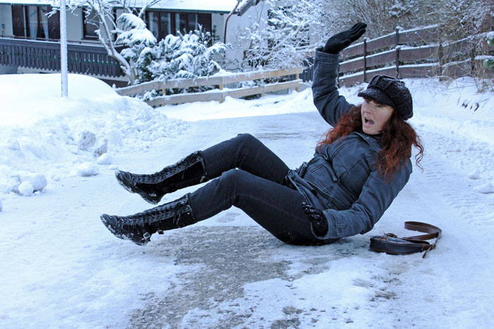 Person slipping on icy sidewalk, illustrating frustration when neighbors don't shovel snow. Person slipping on icy sidewalk, illustrating frustration when neighbors don't shovel snow.