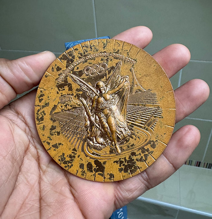 Rusted bronze medal design for French Paris 2024 Olympians, featuring intricate details and iconic symbols. Rusted bronze medal design for French Paris 2024 Olympians, featuring intricate details and iconic symbols.