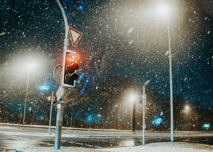 Snowy night scene with traffic lights on, showcasing the weirdest sight while driving at night. Snowy night scene with traffic lights on, showcasing the weirdest sight while driving at night.