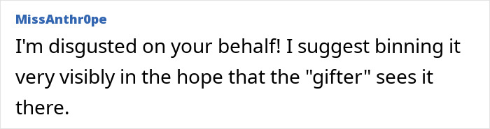 Text comment expressing frustration about a Secret Santa gift, suggesting discarding it visibly. Text comment expressing frustration about a Secret Santa gift, suggesting discarding it visibly.