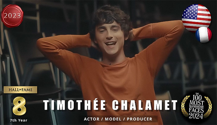 "Handsome men 2024: actor smiling, wearing an orange sweater, with 'The Independent Critics' ranking badge displayed. "Handsome men 2024: actor smiling, wearing an orange sweater, with 'The Independent Critics' ranking badge displayed.