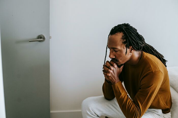 Man sitting in thought in a minimalist room, reflecting on relationship issues and partner dynamics. Man sitting in thought in a minimalist room, reflecting on relationship issues and partner dynamics.