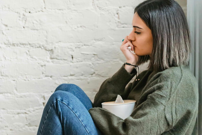 Woman sitting pensively, reflecting on relationship dynamics. Woman sitting pensively, reflecting on relationship dynamics.