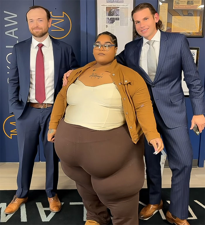 Plus size woman stands with two men in suits, highlighting lawsuit against Lyft for discrimination. Plus size woman stands with two men in suits, highlighting lawsuit against Lyft for discrimination.