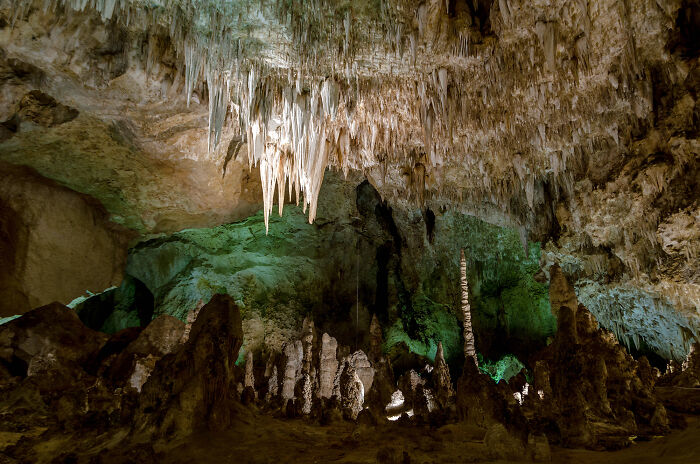Stalactites and stalagmites in a stunning cave in the states, showcasing amazing views.