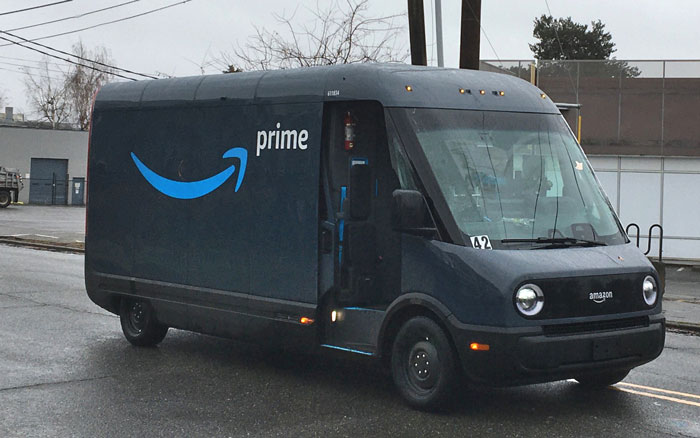 Amazon Prime delivery van parked on a street in rainy weather. Amazon Prime delivery van parked on a street in rainy weather.