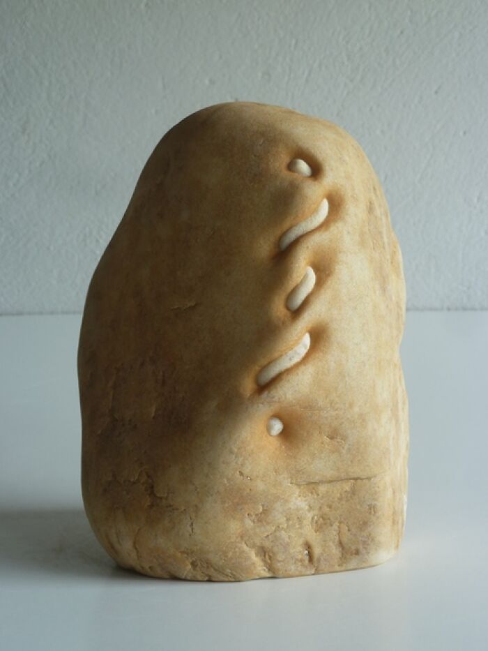 Intricate stone sculpture with smooth, curved lines demonstrating defiance of physics.