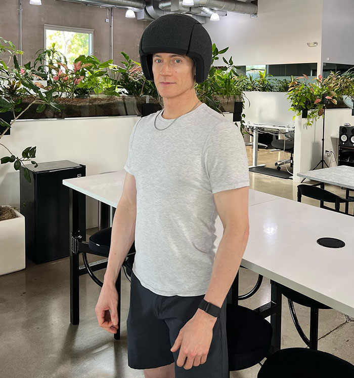 Young man in a casual outfit at a modern office, linked to a billionaire focused on reversing aging. Young man in a casual outfit at a modern office, linked to a billionaire focused on reversing aging.