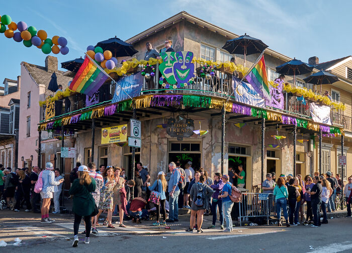 A festive street scene in one of the amazing views states, featuring a decorated corner building and lively crowd.