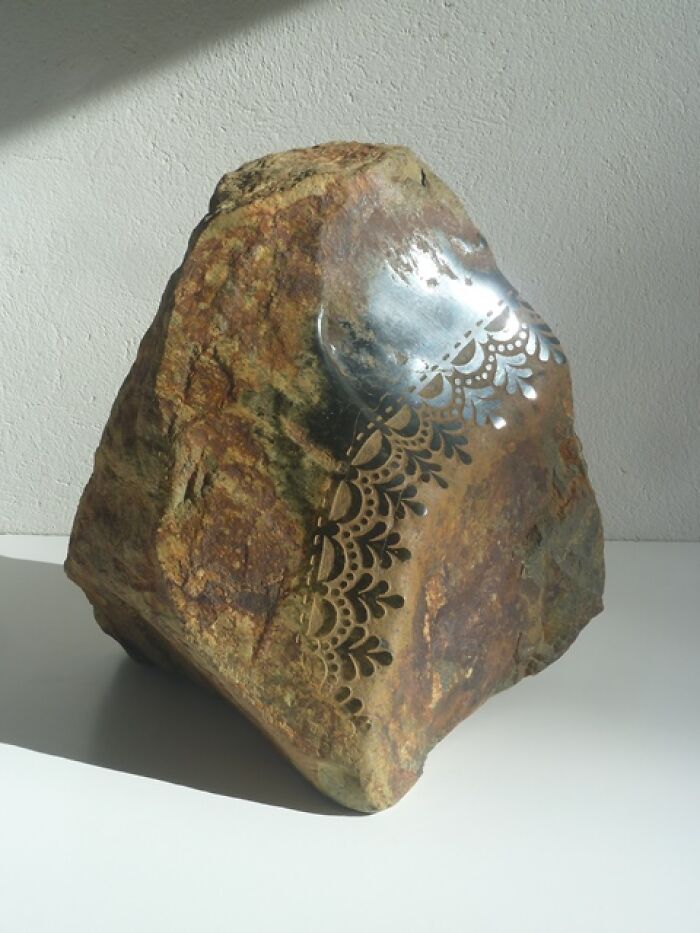 Stone sculpture with intricate metallic detailing, showcasing artistic techniques that appear to defy physics.