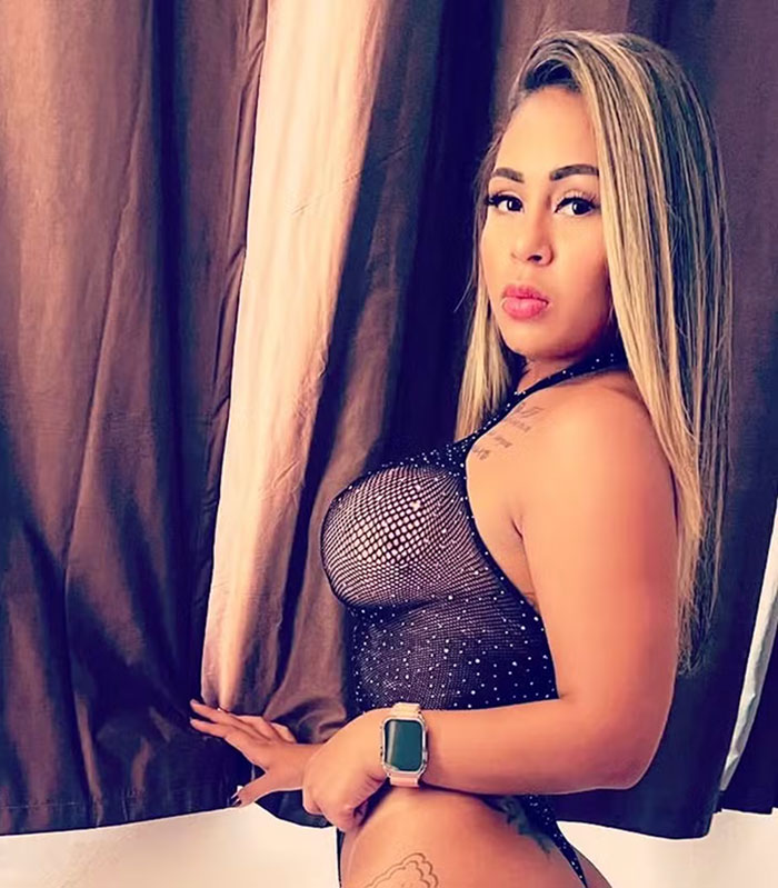 Adult star posing in a revealing outfit near curtains. Adult star posing in a revealing outfit near curtains.