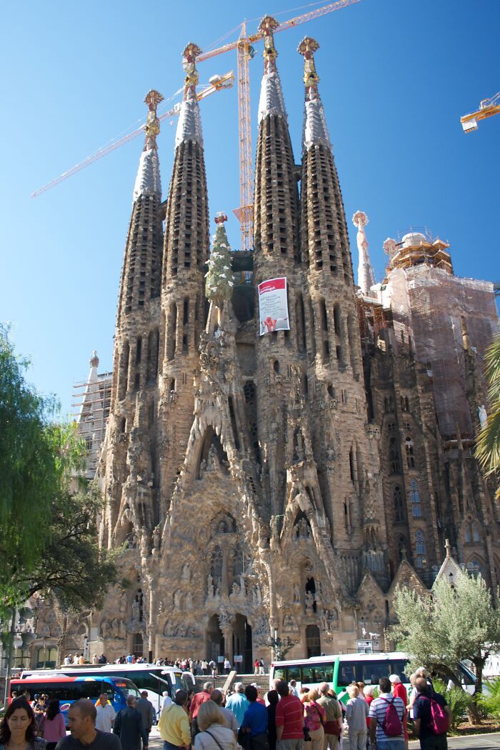 Fascinating church photo of Sagrada Familia in Barcelona, with detailed spires and a clear blue sky.