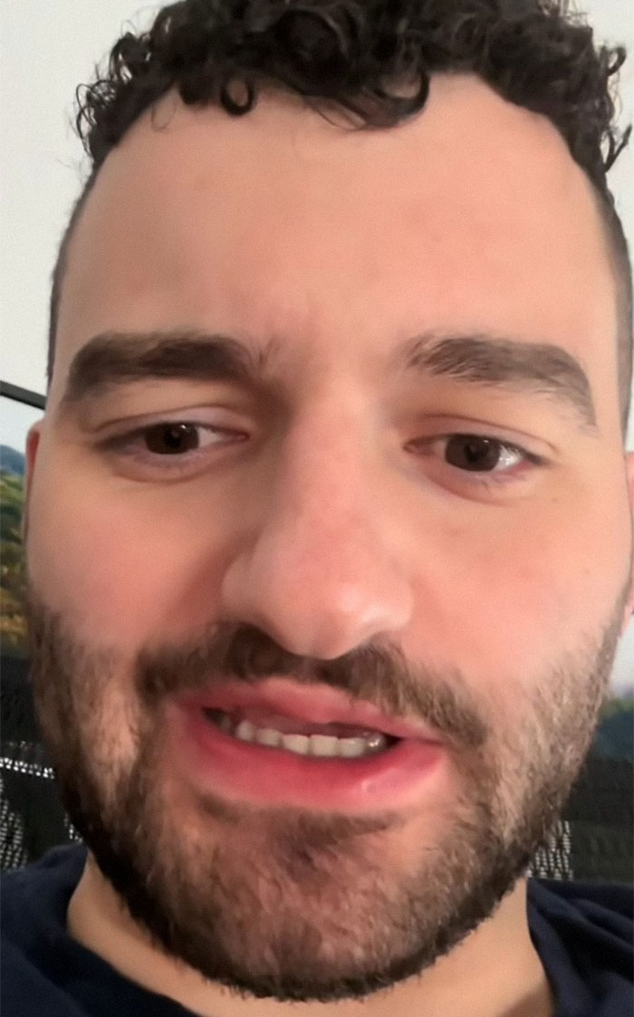 Close-up of a man with curly hair, discussing Airbnb guests taking out the trash. Close-up of a man with curly hair, discussing Airbnb guests taking out the trash.