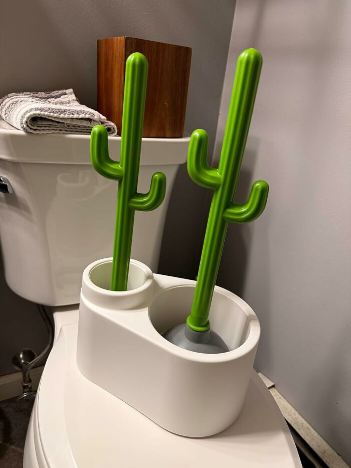 Cactus-shaped toilet brush set on tank; creative home solution for eyesores.