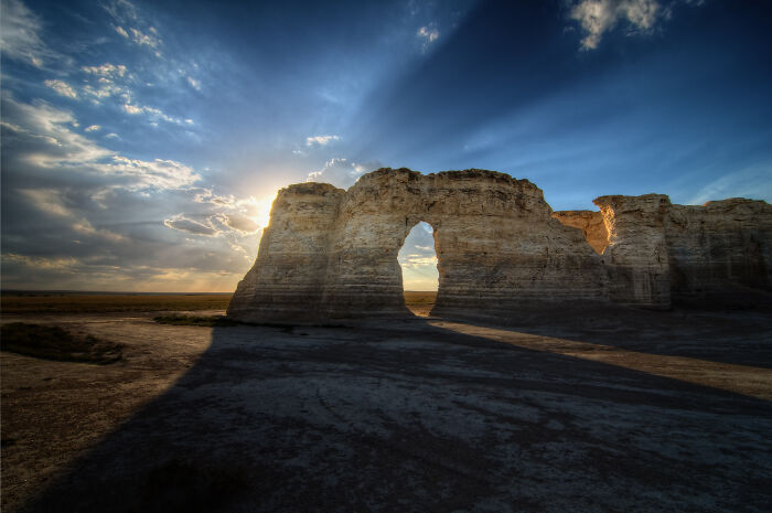 Rock formation with sunset rays in the background, showcasing one of the amazing views in the States.