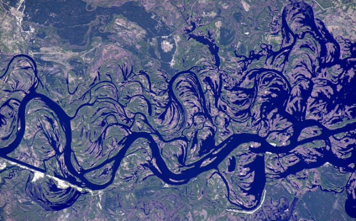 Aerial view of winding river showcasing fascinating patterns in the landscape.
