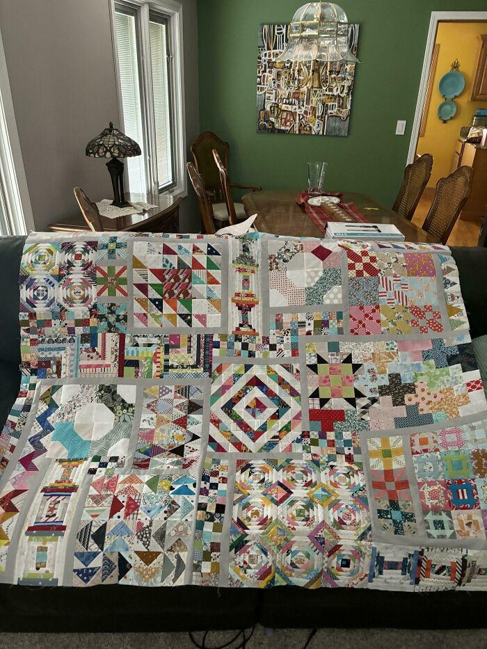 Patchwork quilt displayed on a sofa, showcasing intricate DIY designs that look amazing.