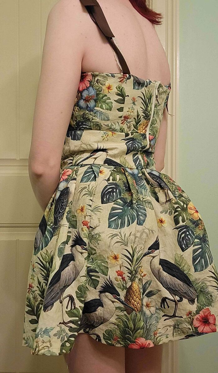 DIY project: a handmade dress with a tropical bird and floral print design.