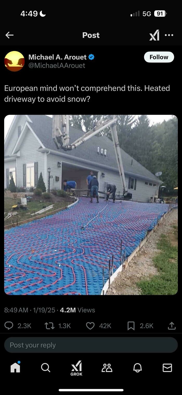 Heated driveway construction with workers installing tubing to avoid snow, showcasing dumbest American posts.