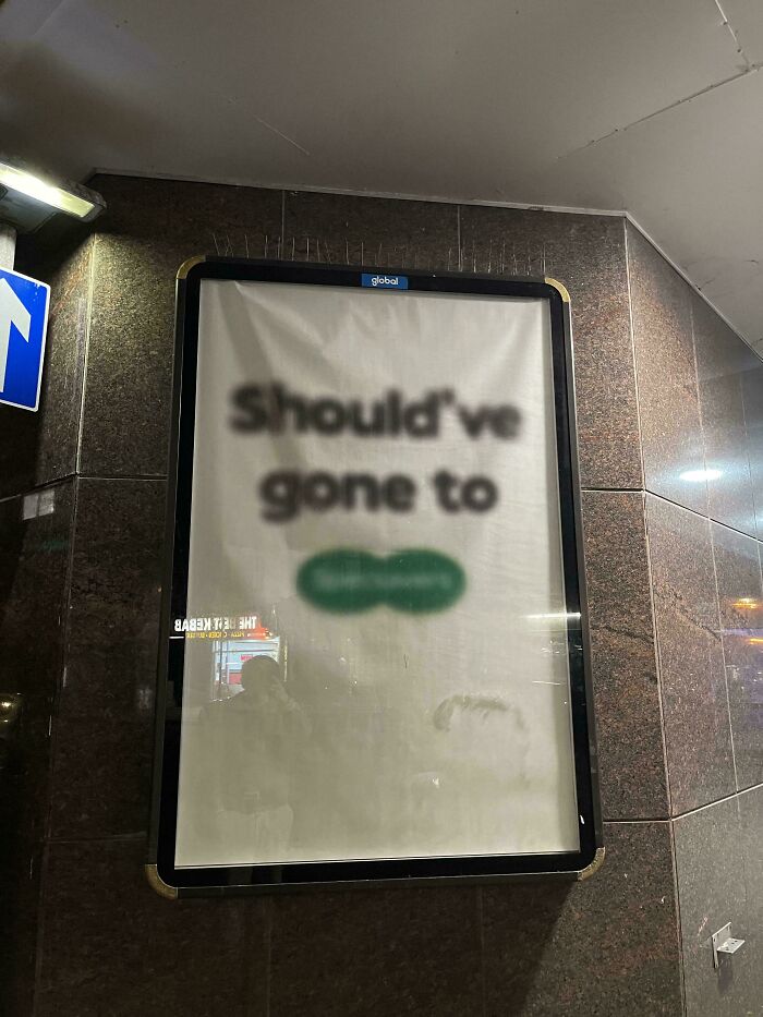 Blurry advertisement with unclear text displayed on a wall, showcasing creative and smart design concepts.