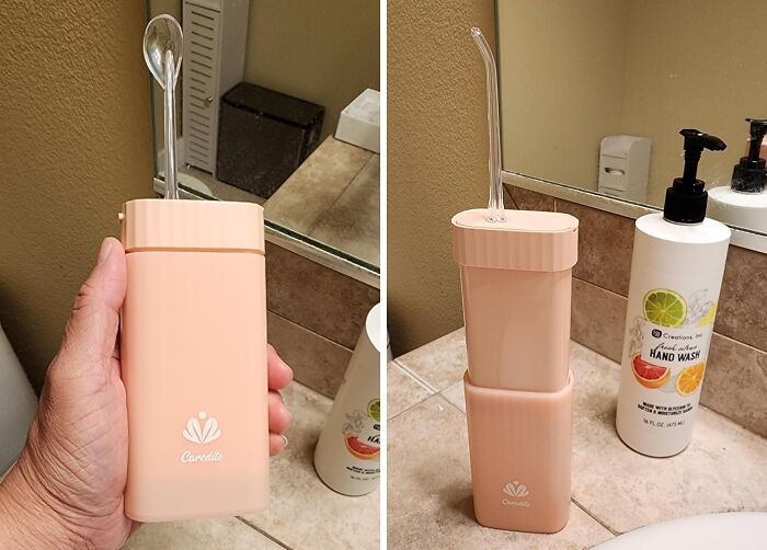 Portable pink oral irrigator, ideal travel accessory, in bathroom with hand wash bottle.