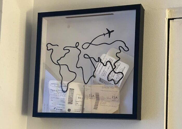 Travel-themed shadow box with flight path art and ticket stubs.