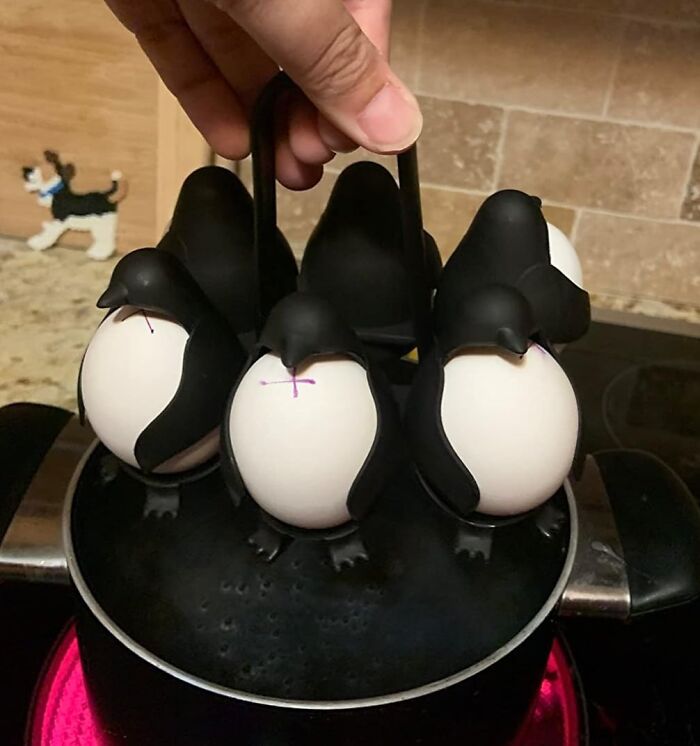 Egg holders shaped like penguins on a pot, exemplifying everyday hacks for an easier life.