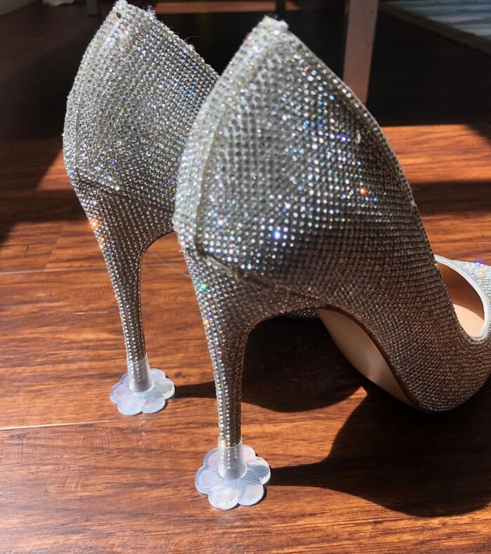 Sparkly high heels with protective grips on a wooden floor, making every day feel like a walk in the park.