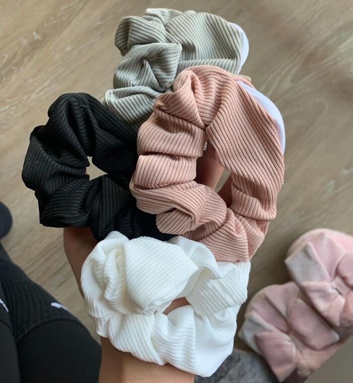 A hand holds a variety of colorful scrunchies, offering simple hacks for everyday ease.
