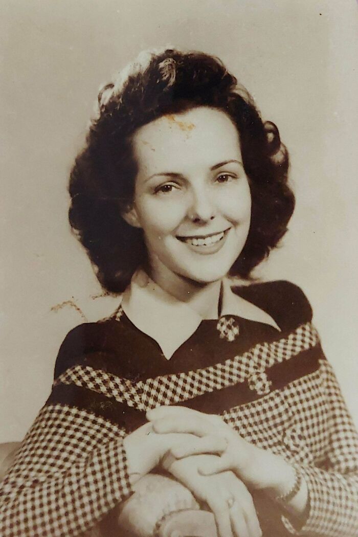 Smiling woman in a vintage checkered outfit, representing old images not commonly seen in history class.