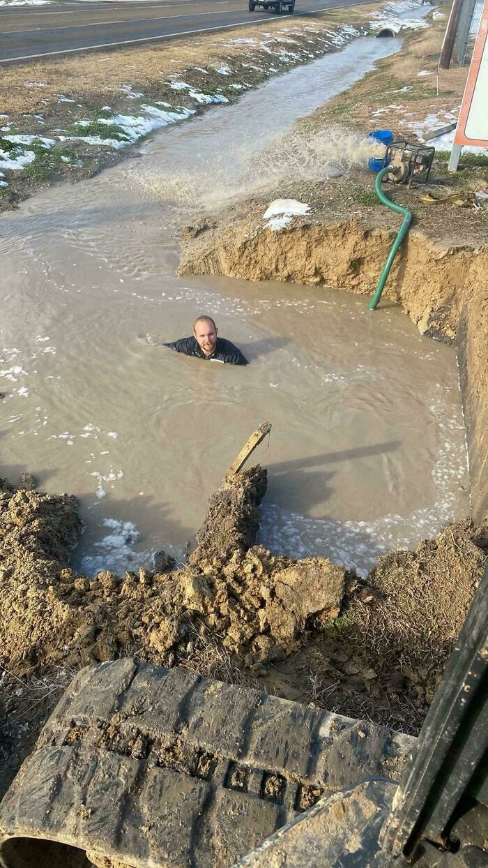 Worker submerged in muddy water at a construction site showing dangerous decisions ignoring safety protocol