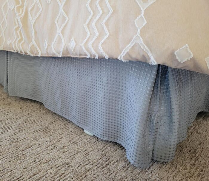 Bed skirt covering under-bed storage to banish eyesores from the home.