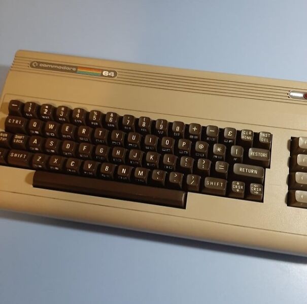 Retro Commodore 64 keyboard on a blue background, evoking nostalgia for the good old days.