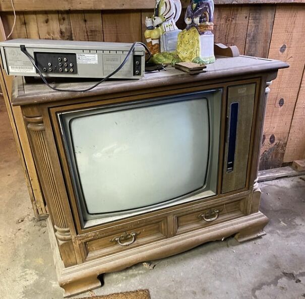 Retro TV set with wood cabinet and attached VCR evokes nostalgia for the good old days.